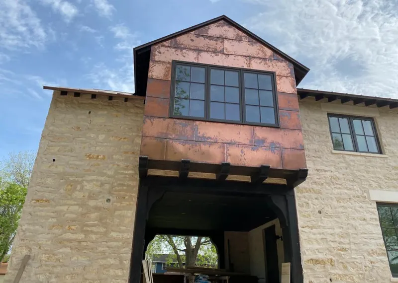 Copper metal panel facade on a stone building for Metal Roof Coating in Benbrook