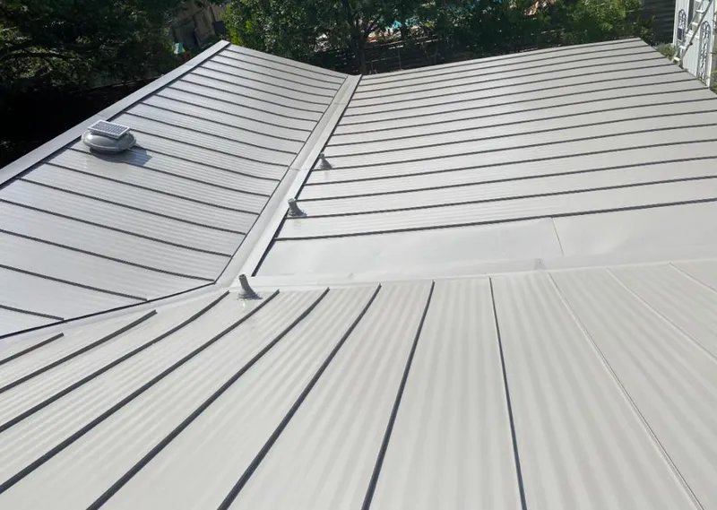 Solar attic fan installed on a metal roof for Roof Ventilation in Benbrook